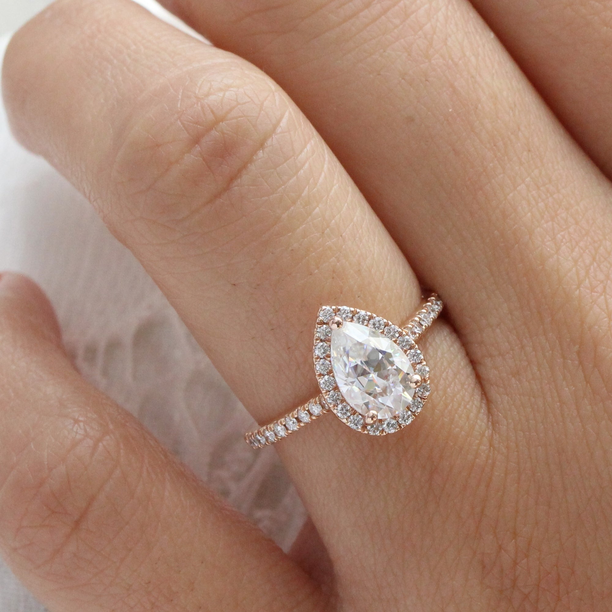 Pear shaped moissanite deals rose gold engagement ring