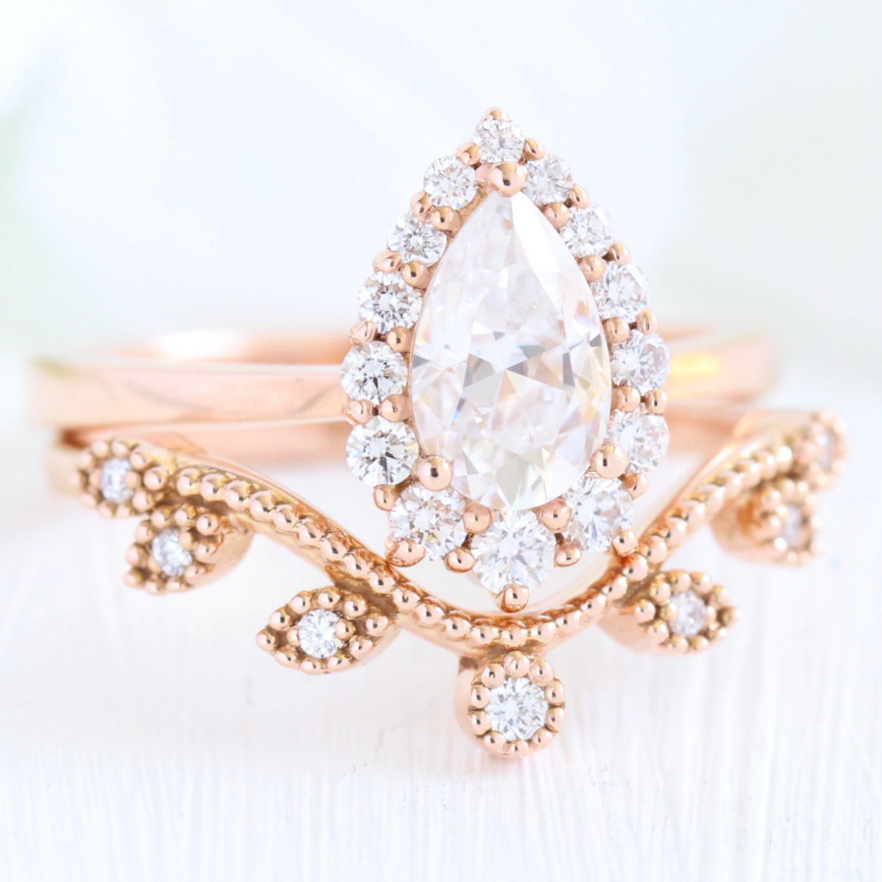 pear moissanite halo diamond engagement ring rose gold and large diamond wedding band by la more design jewelry