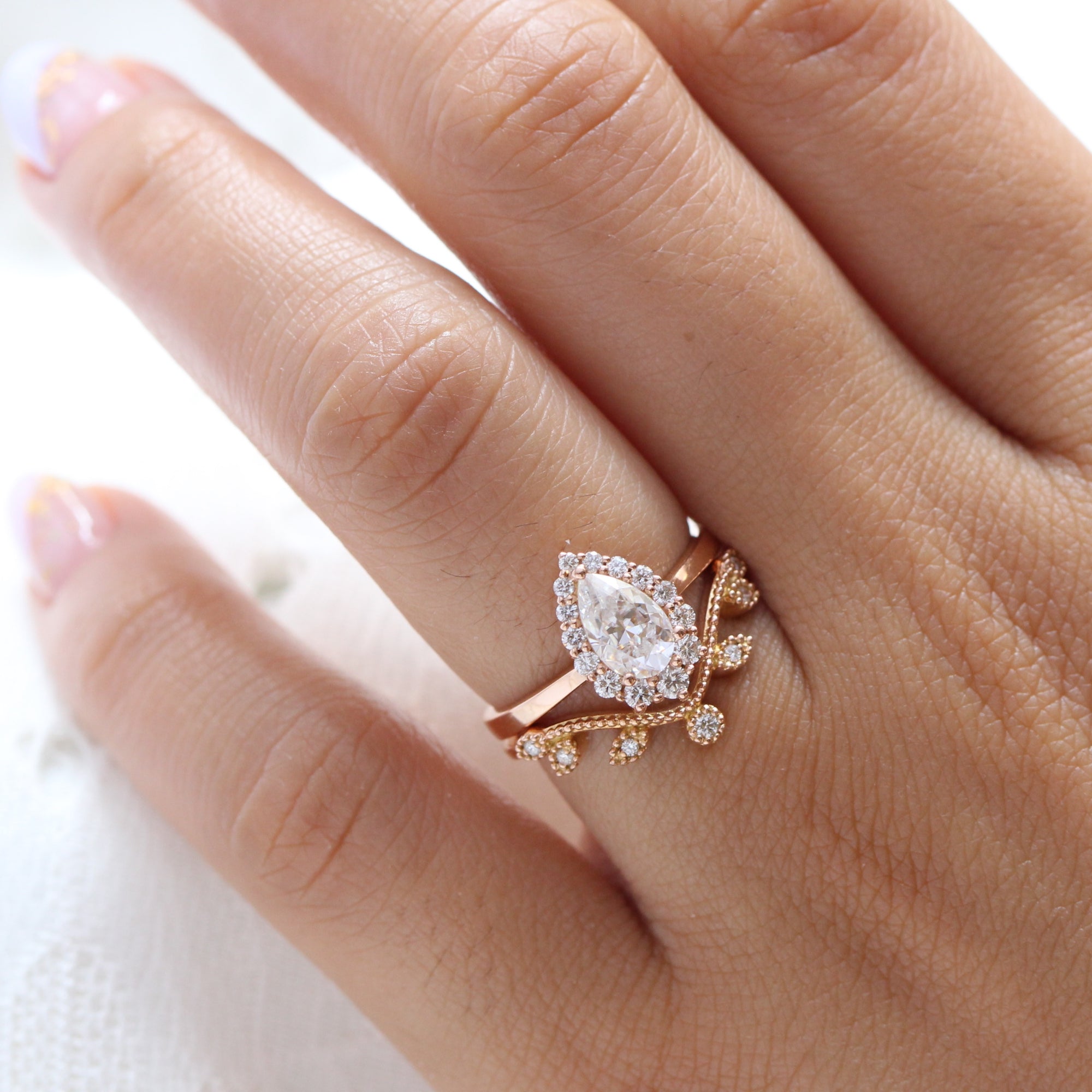 pear moissanite halo diamond engagement ring rose gold and large diamond wedding band by la more design jewelry