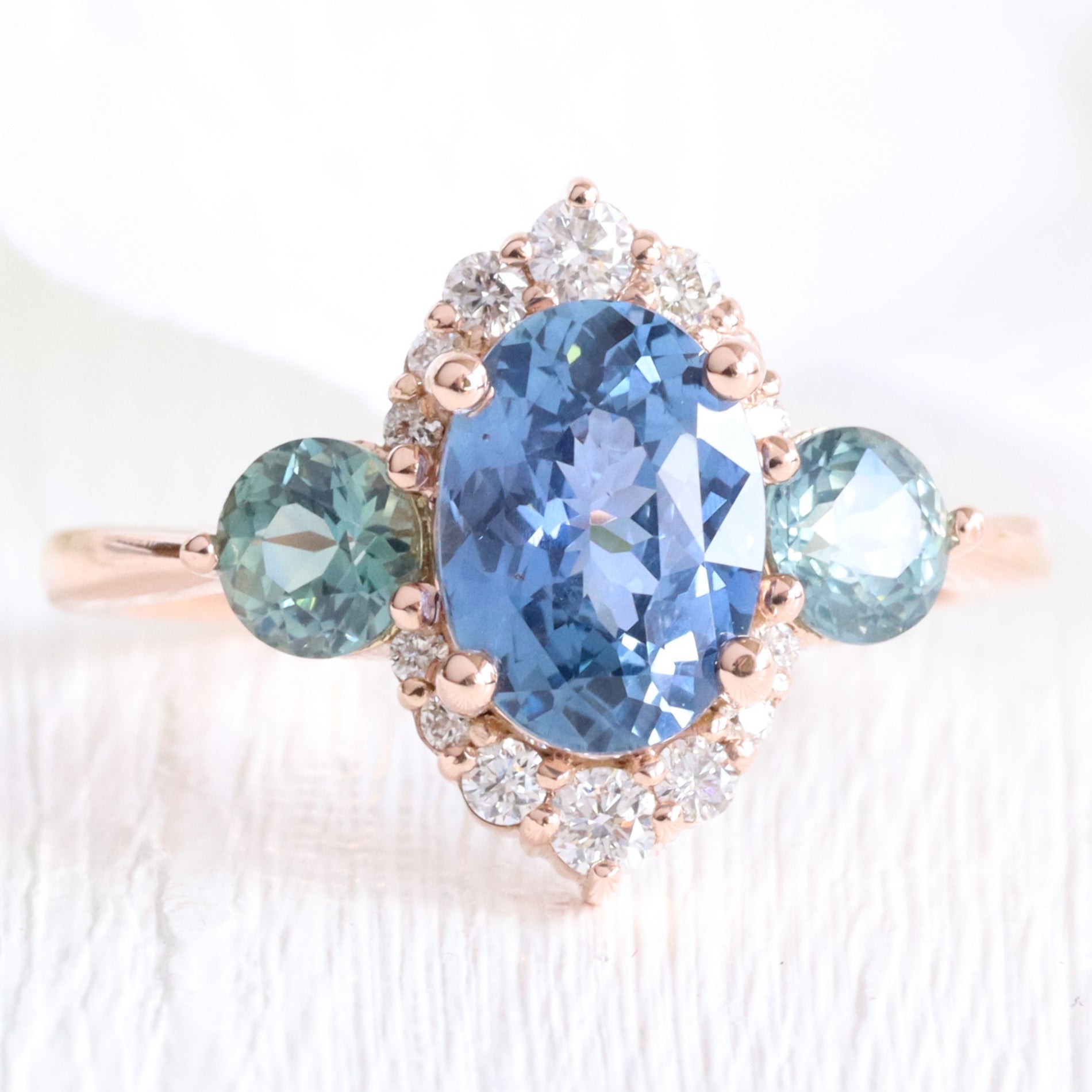 Unique teal blue sapphire ring rose gold diamond halo 3 stone ring la more design jewelry