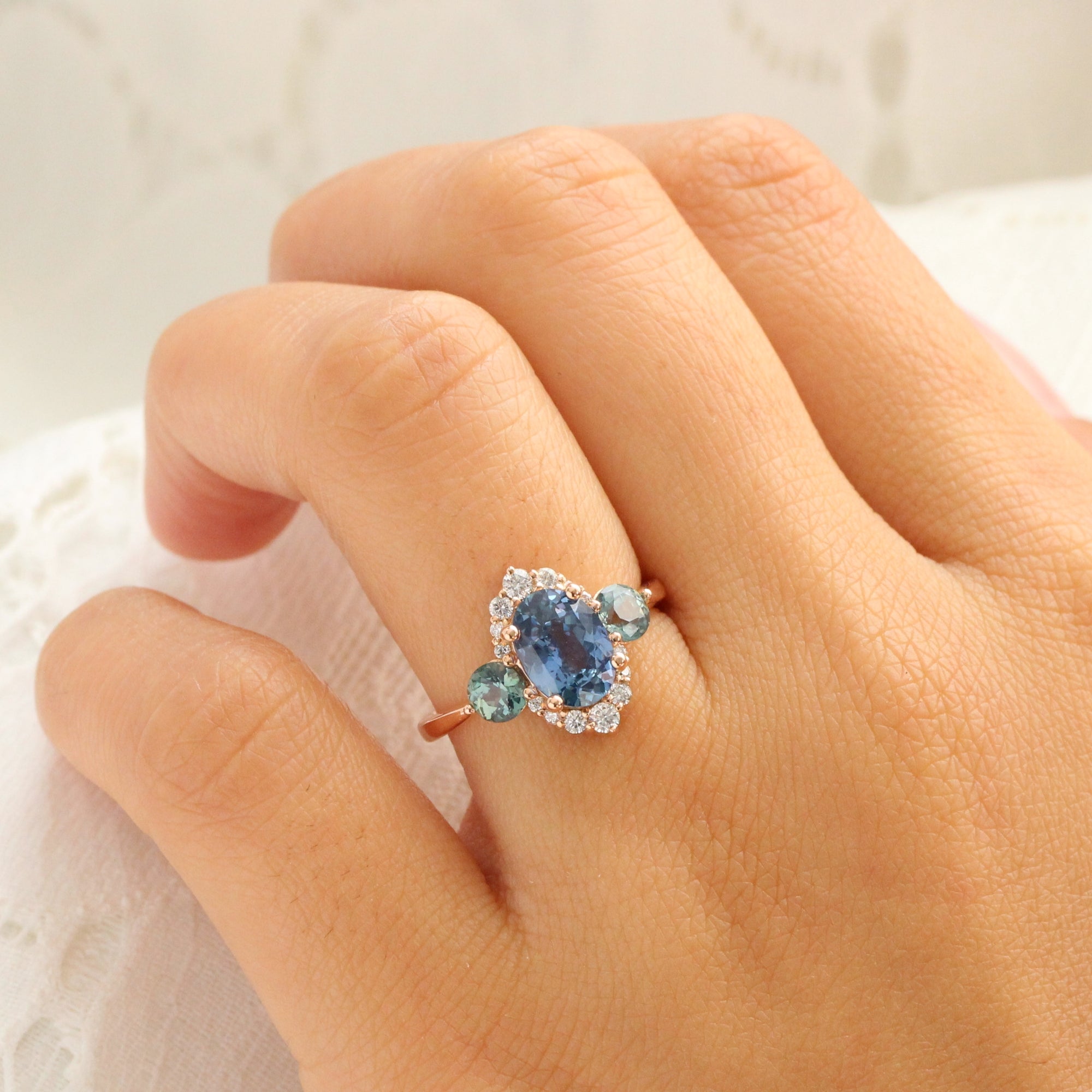 Unique teal blue sapphire ring rose gold diamond halo 3 stone ring la more design jewelry