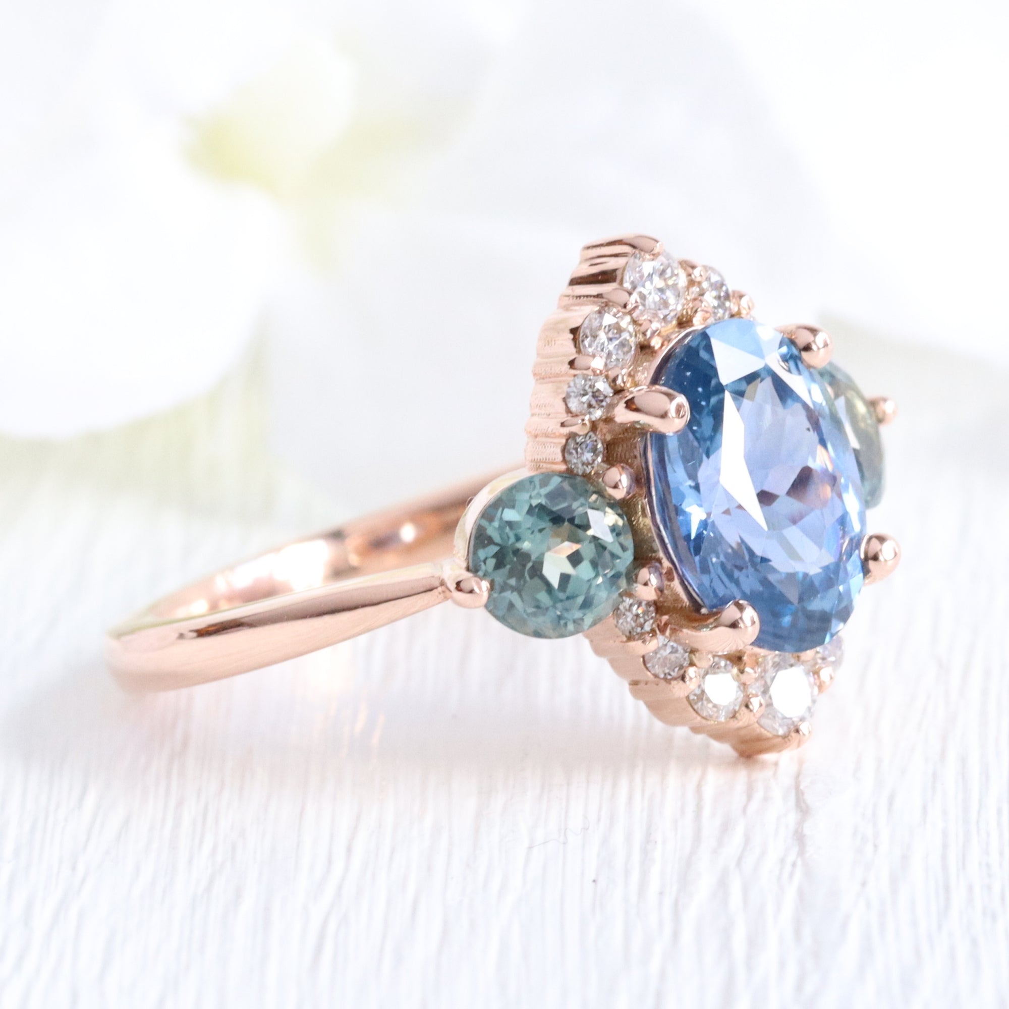 Unique teal blue sapphire ring rose gold diamond halo 3 stone ring la more design jewelry