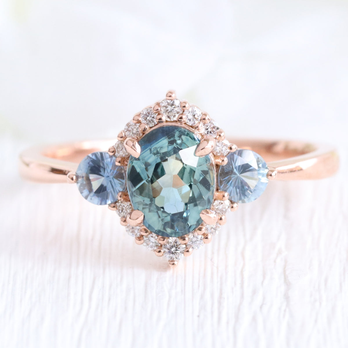 Unique teal blue sapphire ring rose gold diamond halo 3 stone ring la more design jewelry