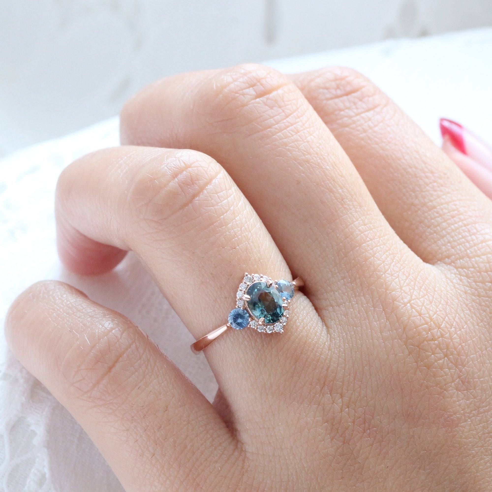 Unique teal blue sapphire ring rose gold diamond halo 3 stone ring la more design jewelry