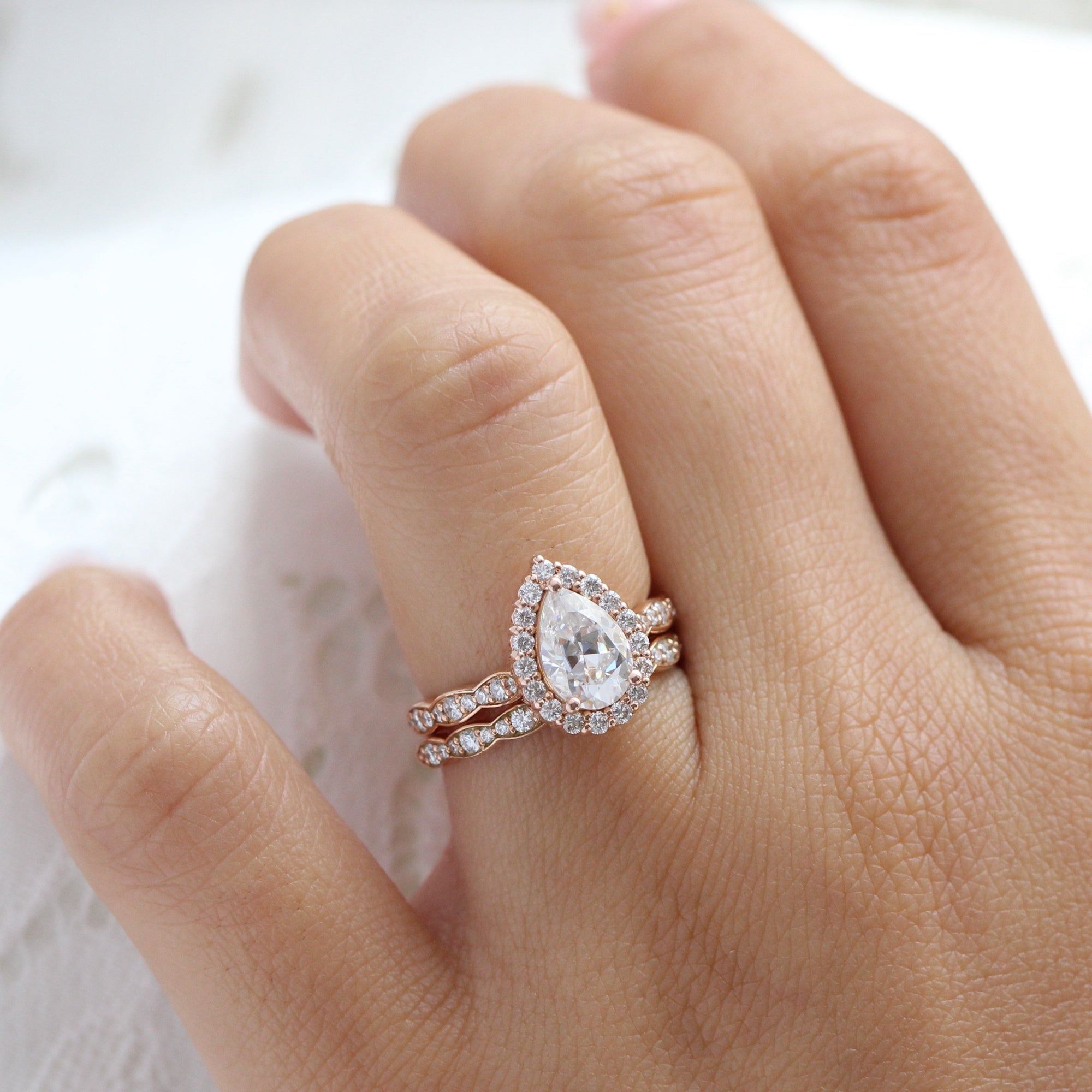 Halo diamond pear moissanite ring bridal set in rose gold scalloped band by la more design jewelry