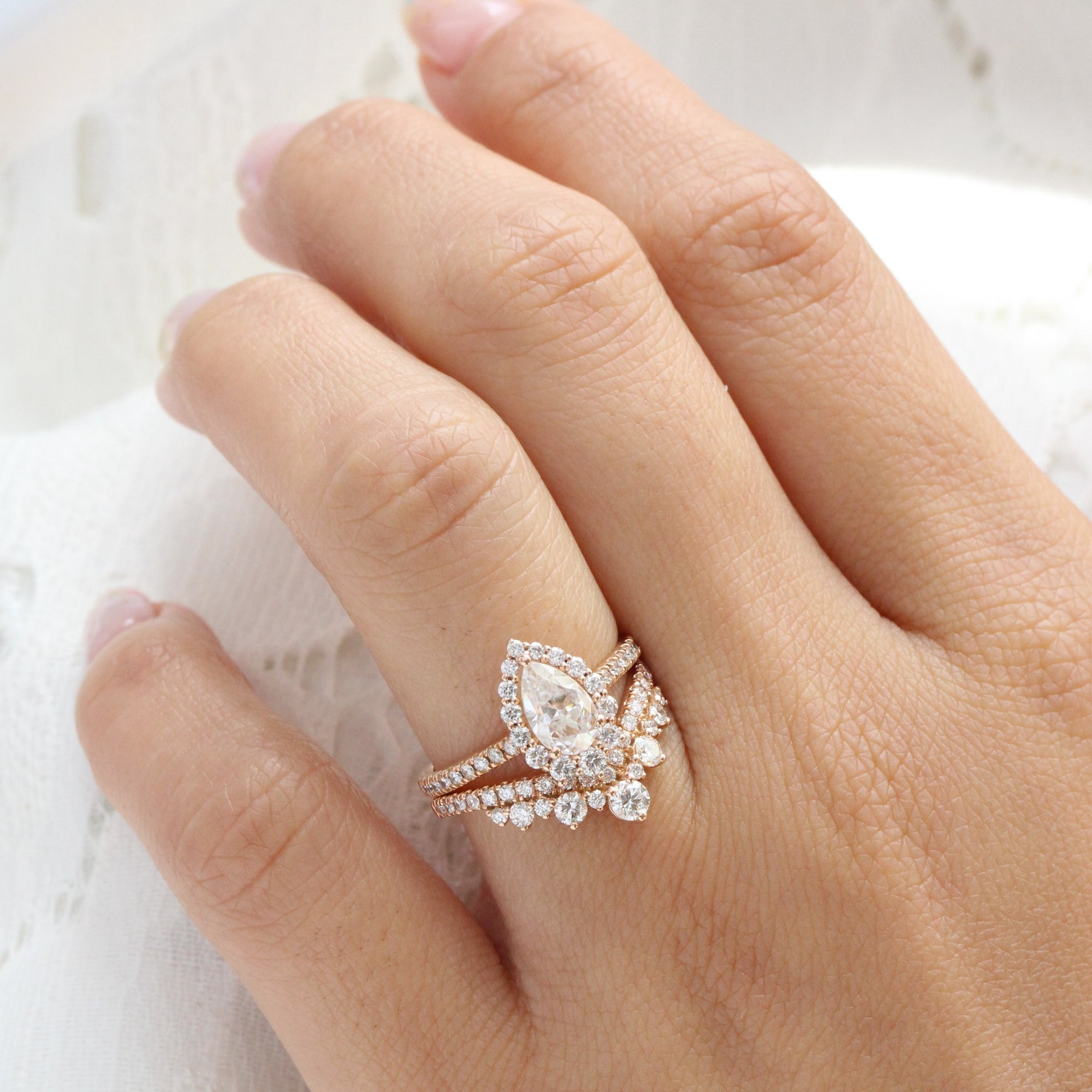 Pear moissanite engagement ring rose gold halo diamond bridal set and contour diamond wedding band by la more design jewelry