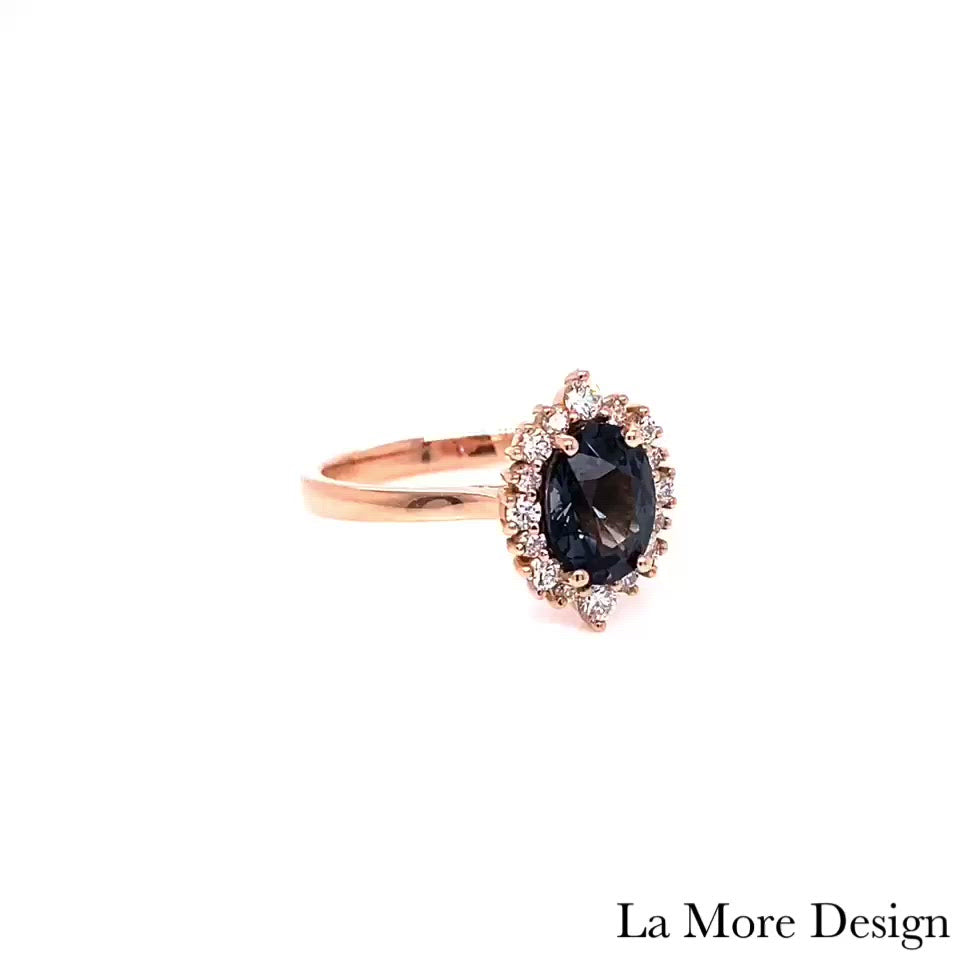 Elegant yet unique grey spinel diamond engagement ring is crafted in a 14k rose gold tiara halo diamond ring setting featuring a 1.33-carat oval cut natural grey spinel center encircled by a halo of brilliant white diamonds to create the truly one of a kind look ~ the total gemstone and diamond weight of the whole ring is 1.63 ct.tw.  