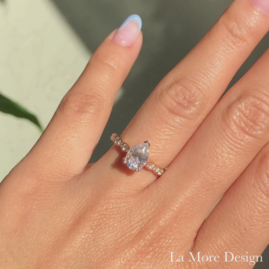 Solitaire pear moissanite engagement ring in rose gold scalloped diamond band by la more design jewelry