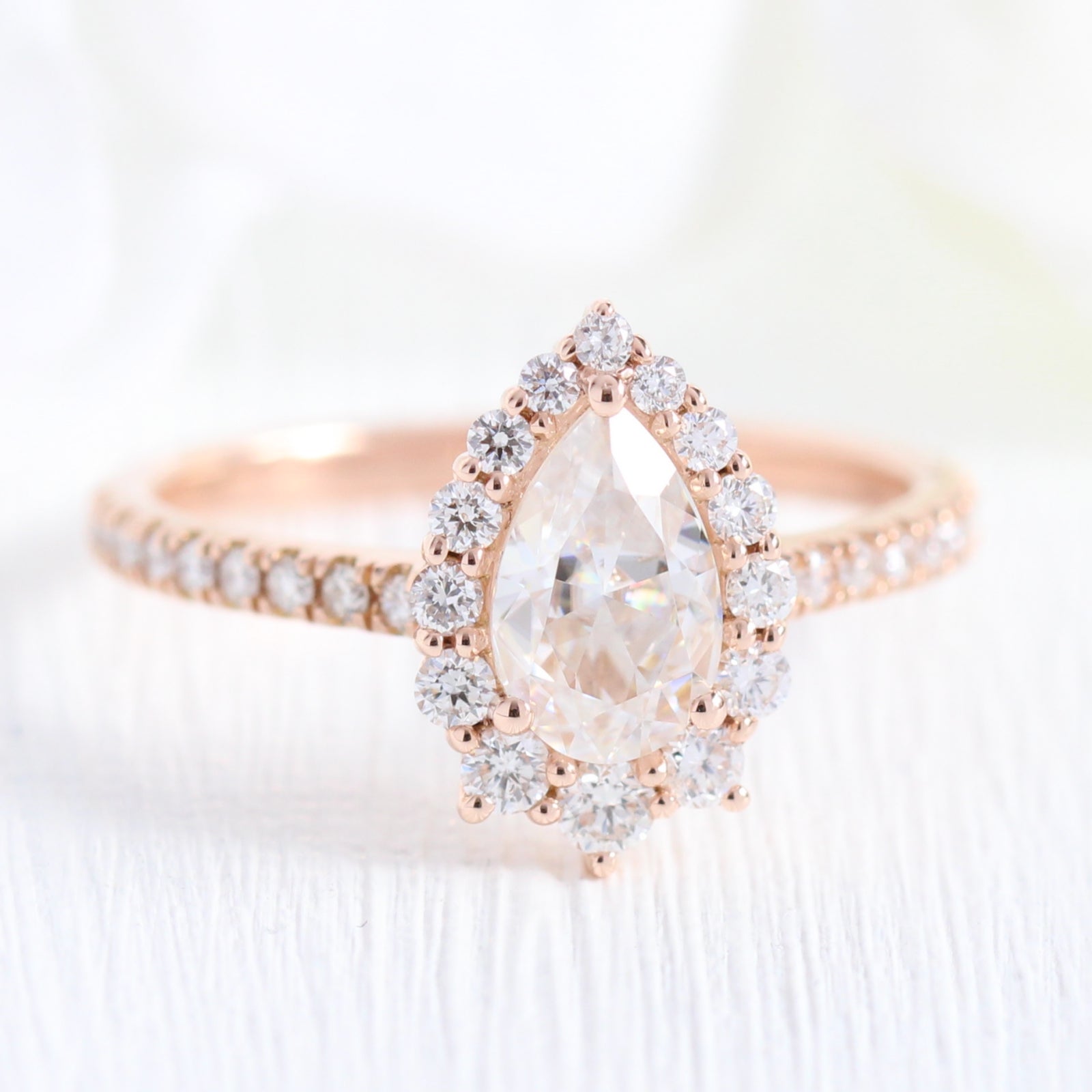 Pear moissanite engagement ring rose gold halo diamond bridal set and contour diamond wedding band by la more design jewelry