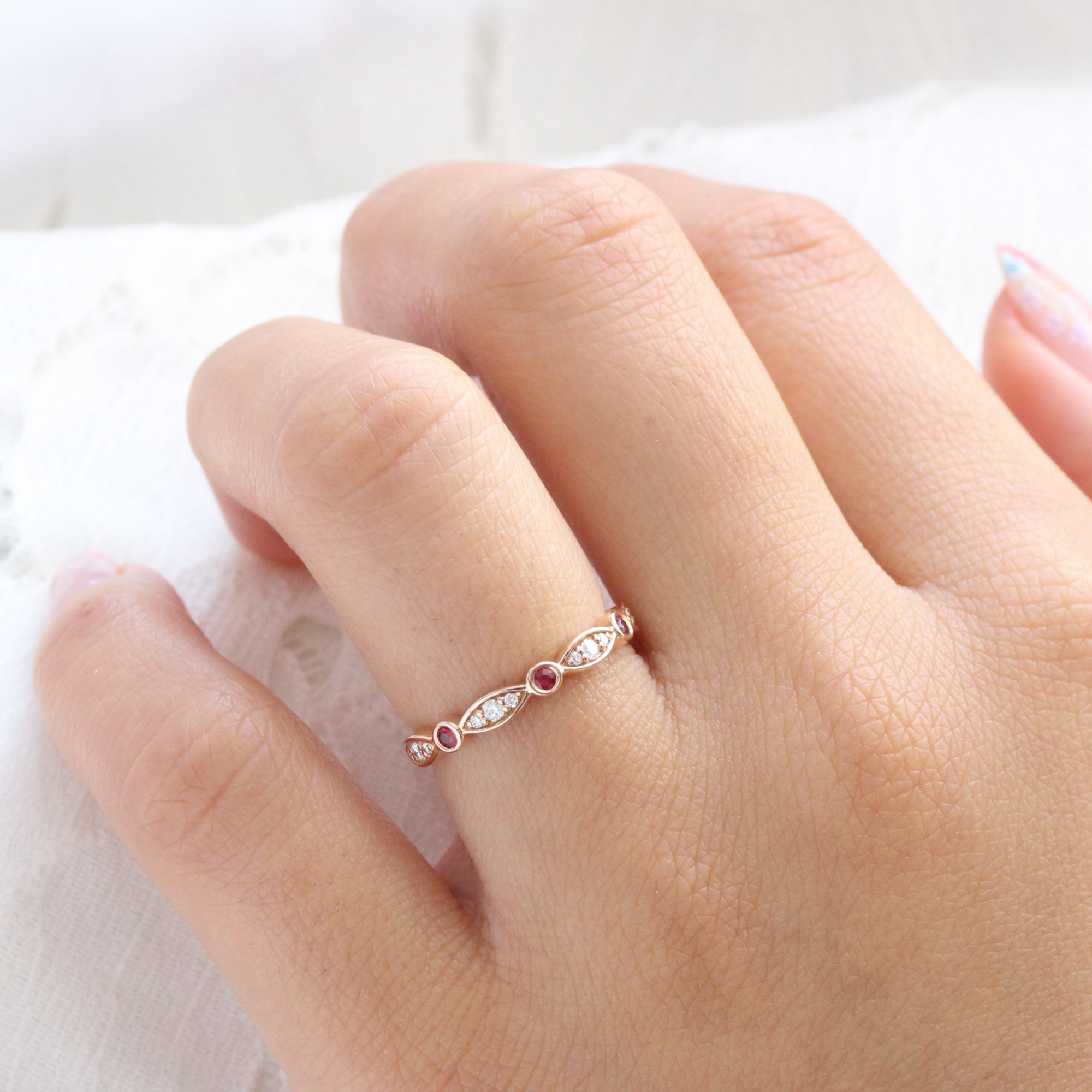 ruby and diamond wedding ring in rose gold bezel set half eternity wedding band by la more design jewelry